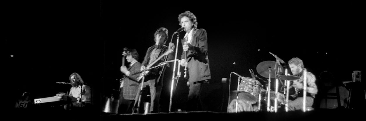 Robbie Robertson performing on guitar with Bob Dylan and The Band, 1974